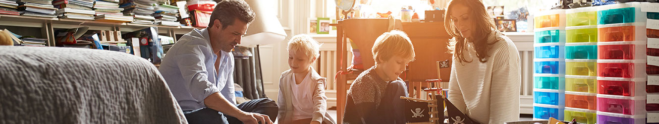 Family playing in a child's room.